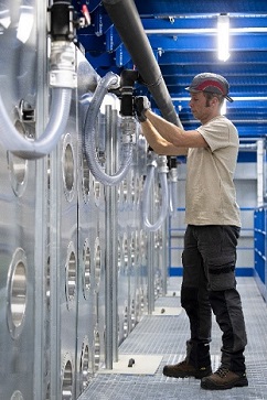 The picture depicts a blue collar worker working inside a building.